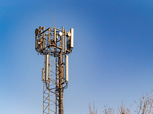 mobile phone mast against a blue sky